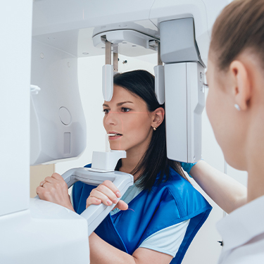 Woman receiving 3 D C T Cone beam dental x-ray