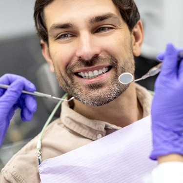 a patient during an oral cancer screening