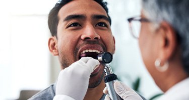 a patient during an oral cancer screening