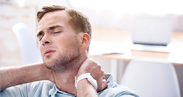 Man holding neck in pain
