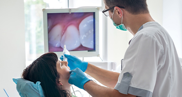 Dentist and patient looking at intraoral images