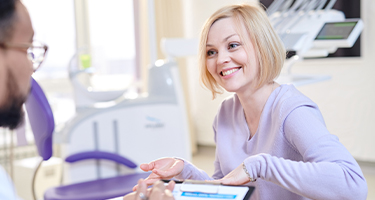 Dentist and patient discussing dental treatment plan