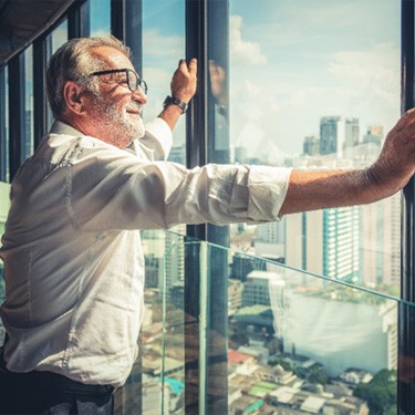 satisfied mature man looking out window 