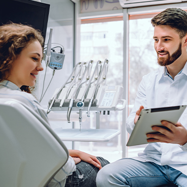 Dentist and patient looking at virtual smile design