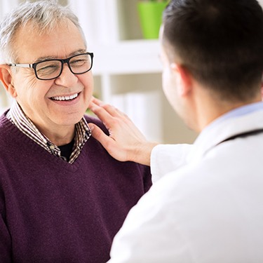 a dentist speaking with a patient