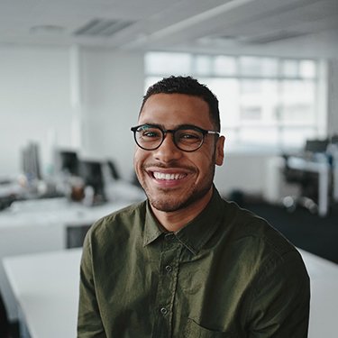 happy man sitting on desk