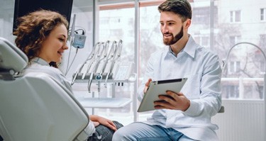 dentist showing a tablet to a patient   