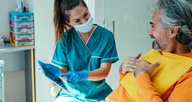 a dentist explaining the cost of tooth extractions