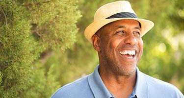 man in a blue polo shirt standing outside 