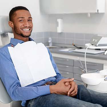 young man sitting in the dental chair 