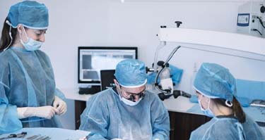 dentists performing dental implant surgery