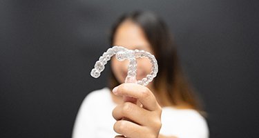 Patient holding clear aligners