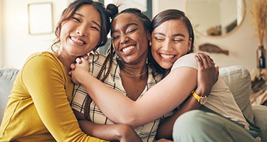 Group of friends smiling on couch