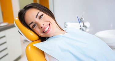 Patient smiling while relaxing in treatment chair