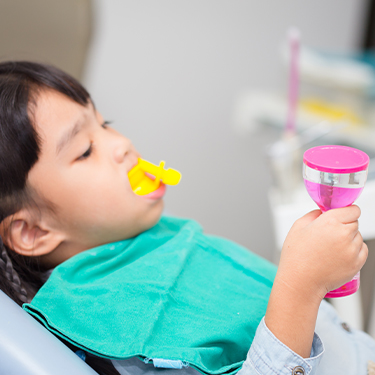 Child receiving fluoride treatment