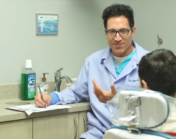 Doctor Oshins talking to a dental patient