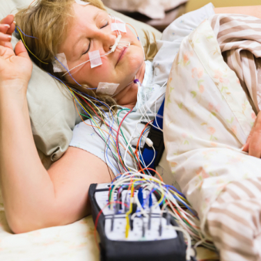 Woman connected to sleep apnea testing device