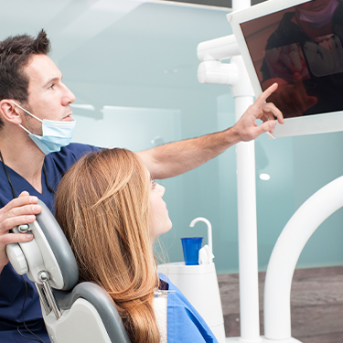 Dentist and patient looking at intraoral images