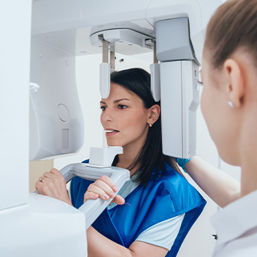 Woman receiving 3 D C T Cone beam dental x-ray