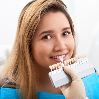 Woman smiling during porcelain veneers consultation