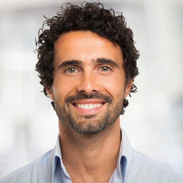Man with curly hair smiling
