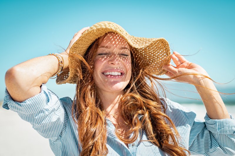 woman smiling on the beach during summer