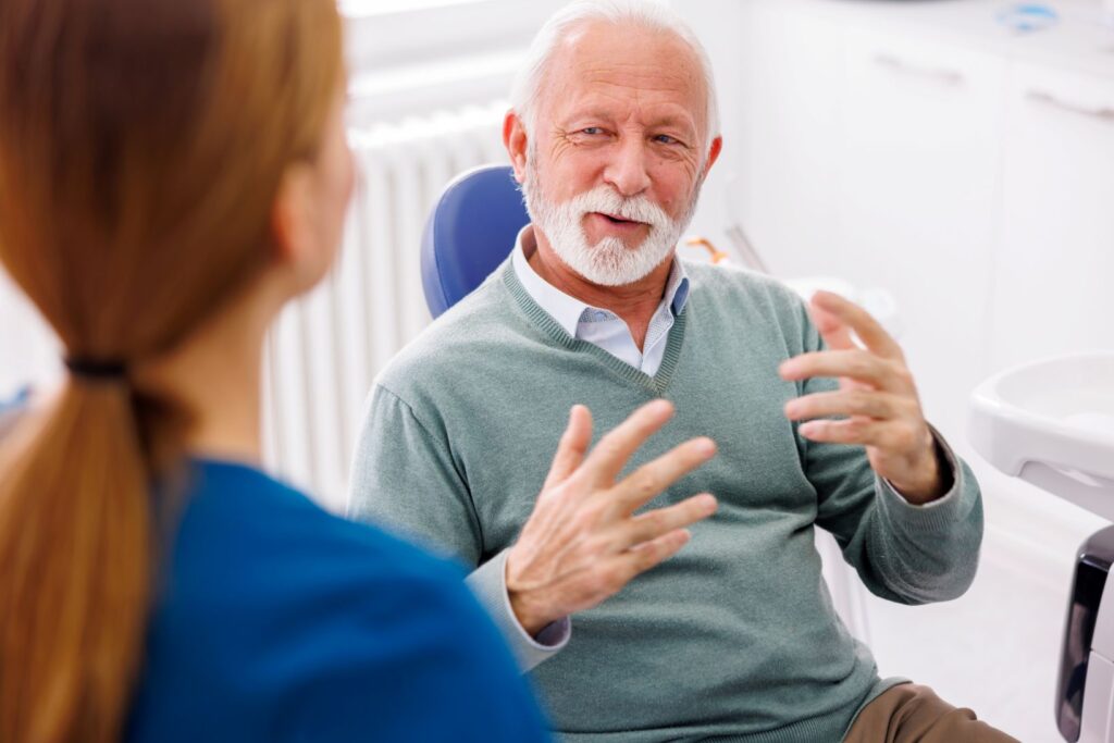 A man asking a dentist an oral health question