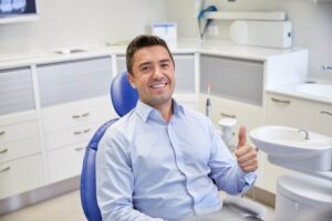 Adult man smiling after his fluoride treatment