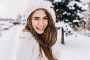 Happy woman outside in snow 